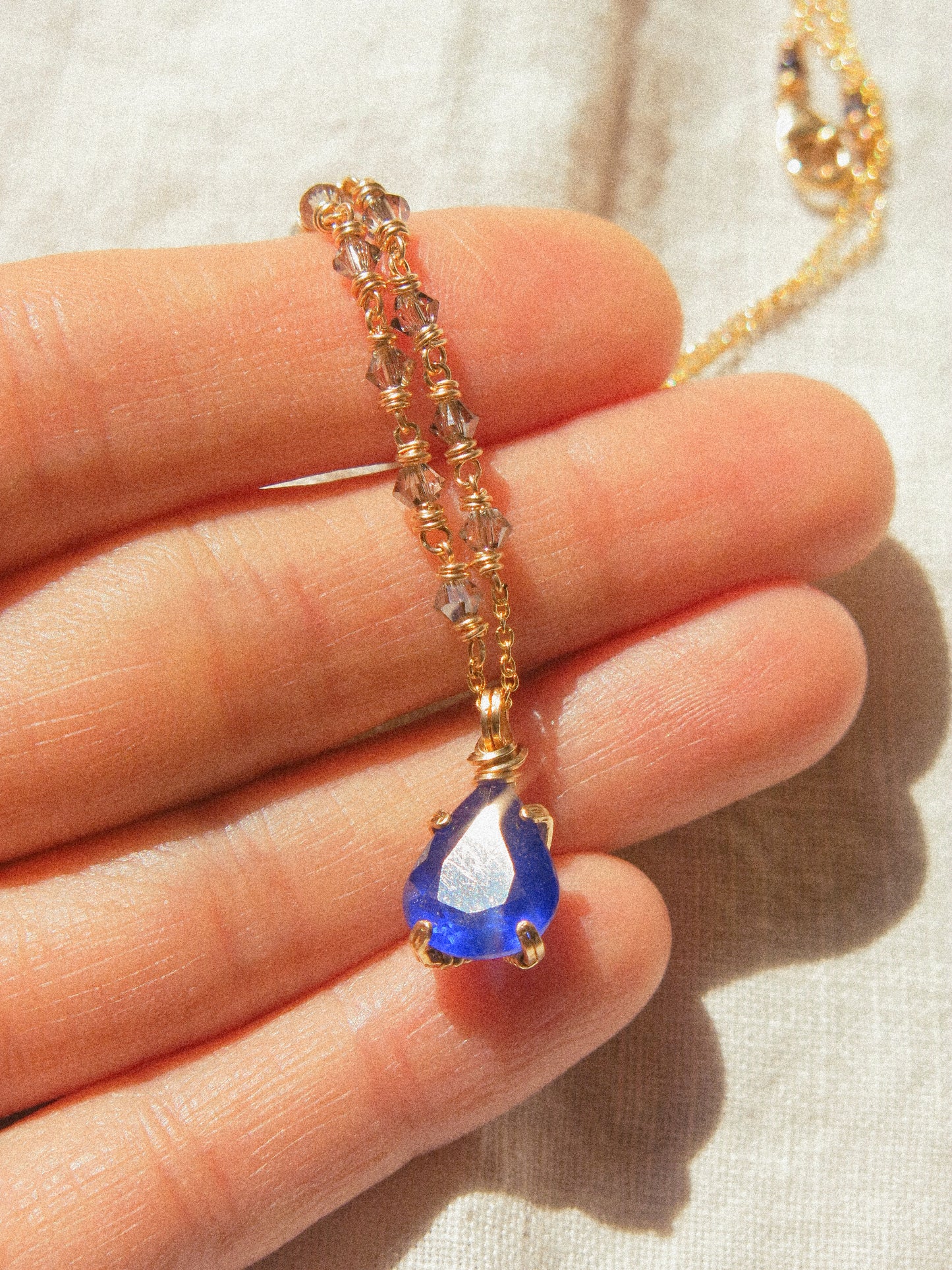 Indigo: Prong Set Teardrop Faceted Blue Sapphire Necklace with Swarovski Crystal Accent Chain, 14K Gold Fill