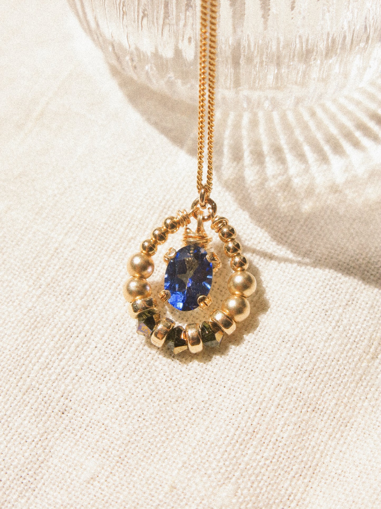 Suila Necklace #2 with Faceted Blue Topaz in Prong Setting with Beaded Frame in Swarovski Crystals, 14K Gold Fill