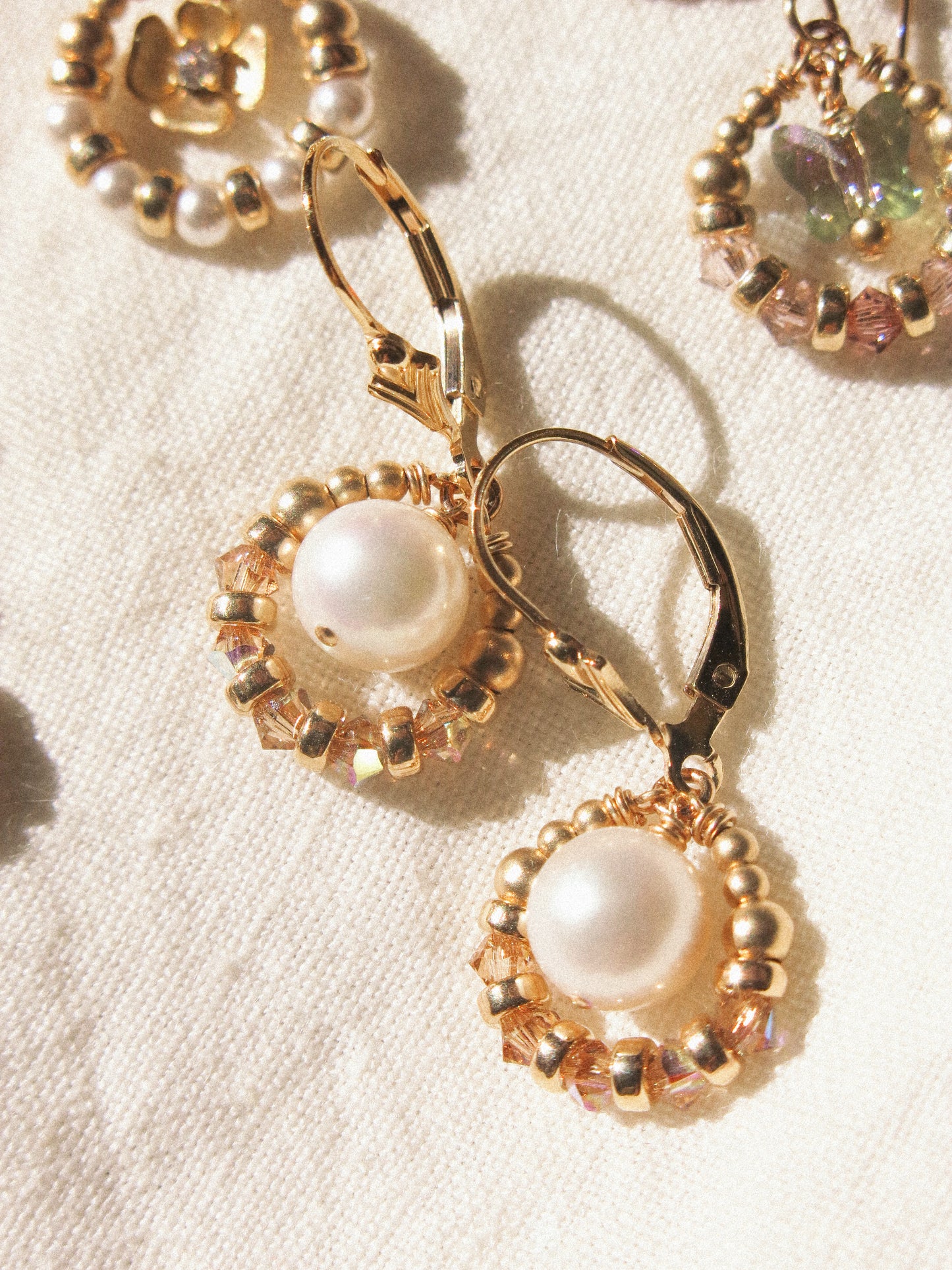 Suila Earrings with White Round Pearl and Gold Champagne Swarovski Crystal, 14K Gold Fill, Fleur de Lis Lever Back Earrings