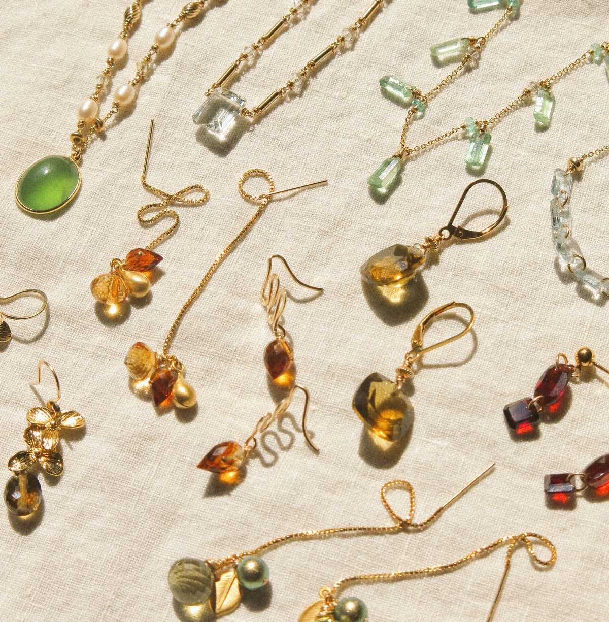 warm tone handmade 14K gold filled gemstone jewelry necklaces and earrings with gemstones including citrine, kyanite, garnet, quartz, aquamarine, and pearls
